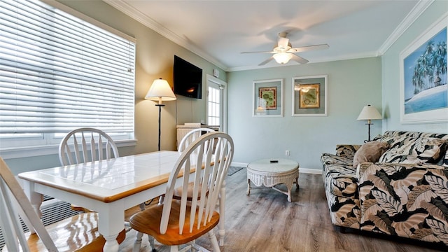 dining space featuring crown molding, light hardwood / wood-style floors, and ceiling fan