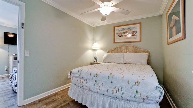 bedroom with ceiling fan, hardwood / wood-style flooring, and ornamental molding