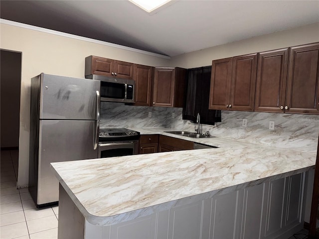 kitchen with appliances with stainless steel finishes, tasteful backsplash, sink, kitchen peninsula, and light tile patterned floors