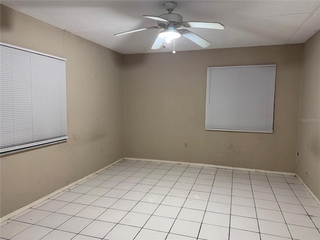 spare room with ceiling fan and a textured ceiling