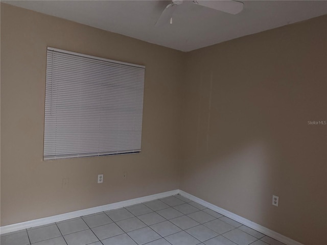 tiled spare room with ceiling fan