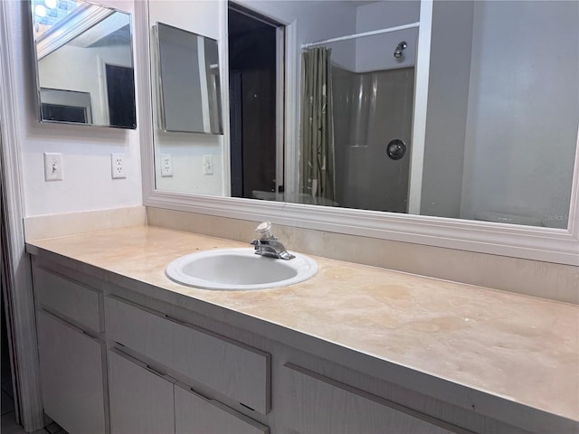 bathroom with vanity and a shower with shower curtain