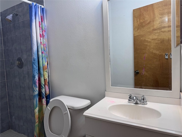 bathroom featuring vanity, toilet, and walk in shower