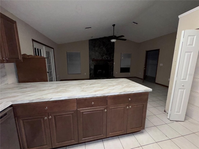 kitchen with dark brown cabinetry, dishwasher, and vaulted ceiling