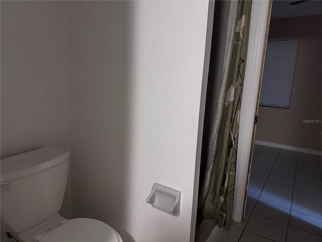 bathroom with toilet and tile patterned floors