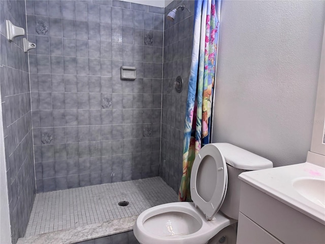 bathroom with vanity, toilet, and curtained shower