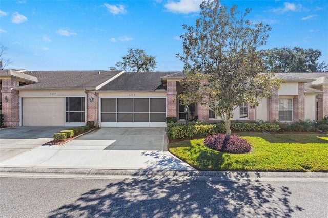 view of front of house with a garage and a front yard