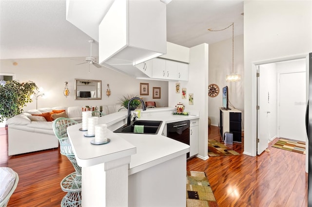 kitchen featuring kitchen peninsula, sink, black dishwasher, and a kitchen bar