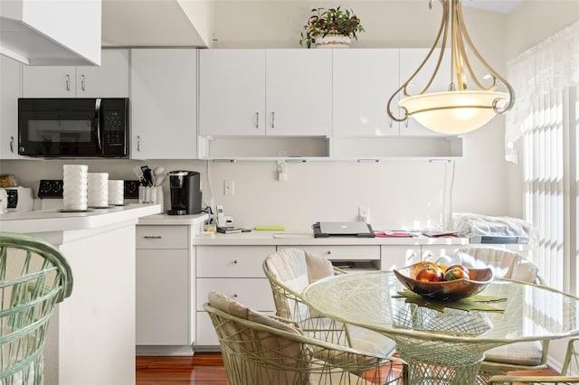 kitchen with hanging light fixtures and white cabinets