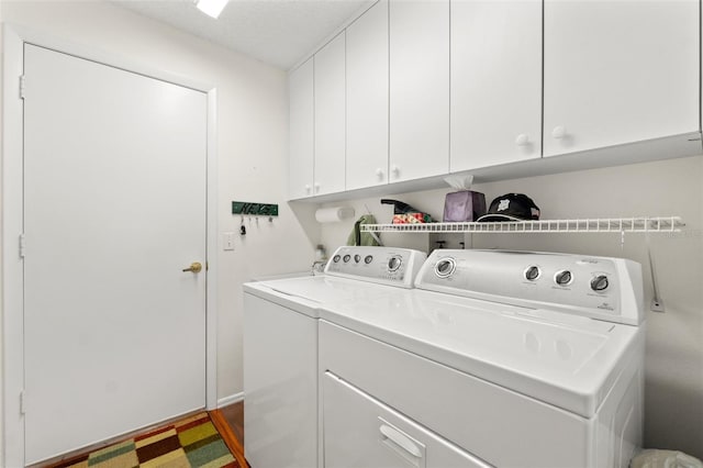 laundry room with cabinets and separate washer and dryer