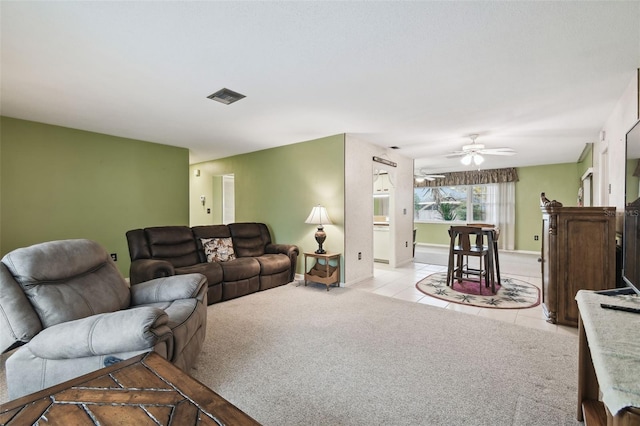 living room featuring ceiling fan and light carpet