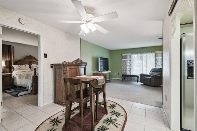 dining space with light carpet and ceiling fan