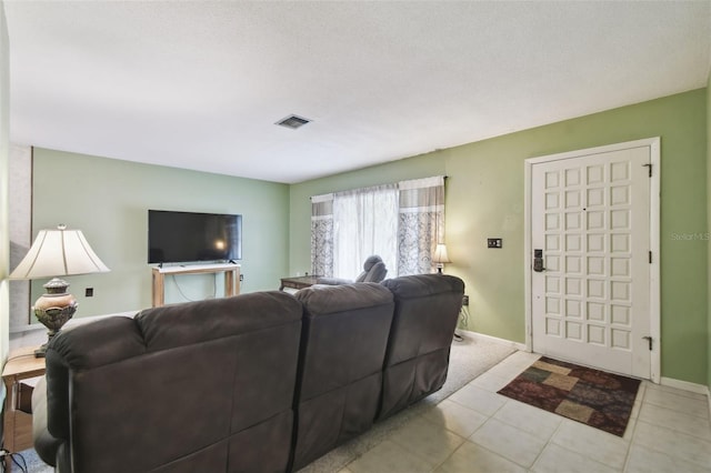 tiled living room with a textured ceiling