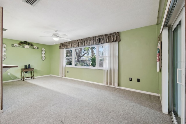 carpeted empty room featuring ceiling fan