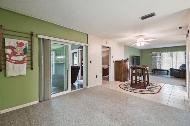 carpeted living room with ceiling fan