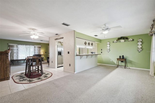 carpeted living room featuring ceiling fan