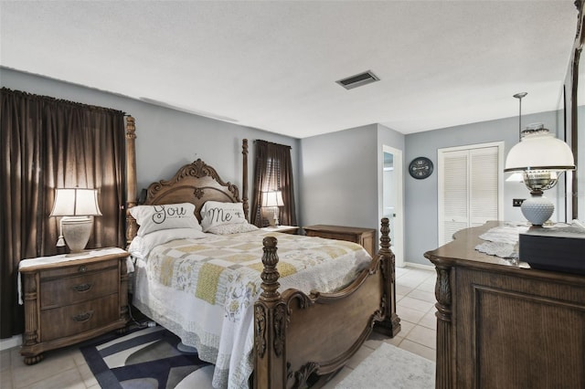 tiled bedroom with a closet