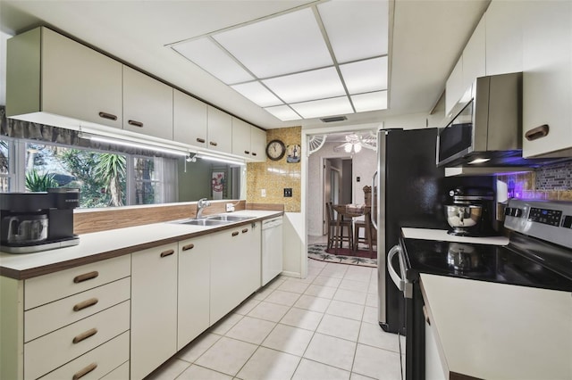 kitchen featuring appliances with stainless steel finishes, white cabinetry, and sink