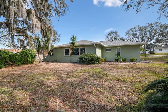 rear view of property featuring a yard