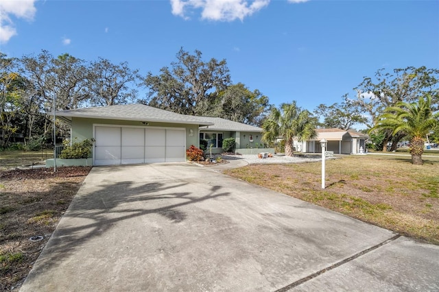 single story home featuring a garage and a front yard