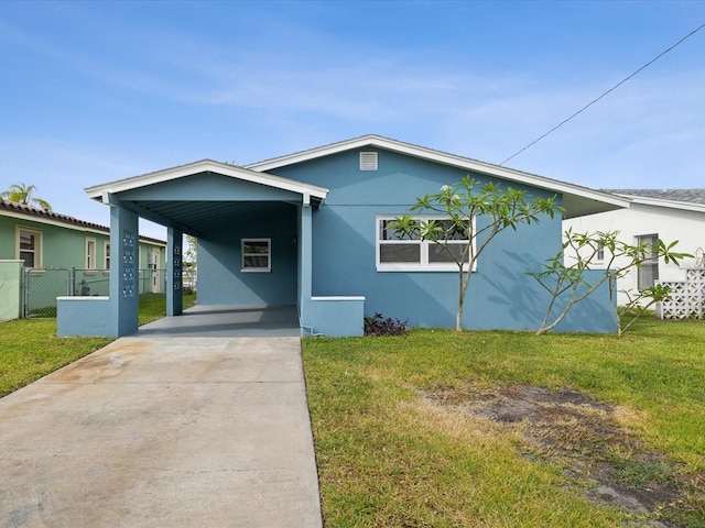 view of front of house with a front lawn and a carport