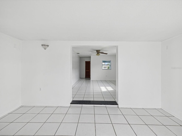 tiled spare room with ceiling fan