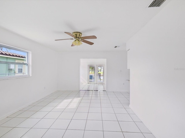 spare room featuring ceiling fan, light tile patterned floors, and french doors