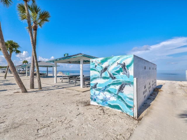 view of pool with a beach view, a gazebo, and a water view