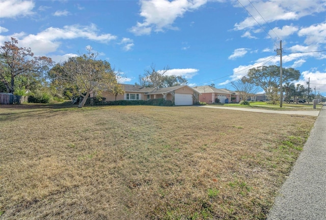 ranch-style house with a garage and a front lawn