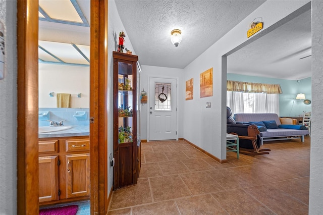 entrance foyer featuring sink and a textured ceiling