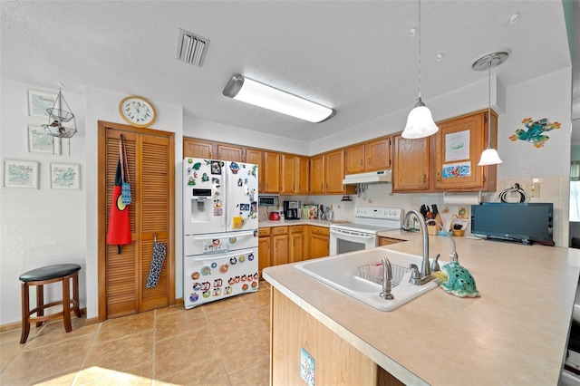 kitchen featuring a textured ceiling, light tile patterned floors, kitchen peninsula, pendant lighting, and white appliances