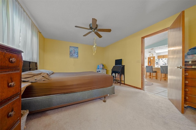 bedroom featuring light colored carpet and ceiling fan