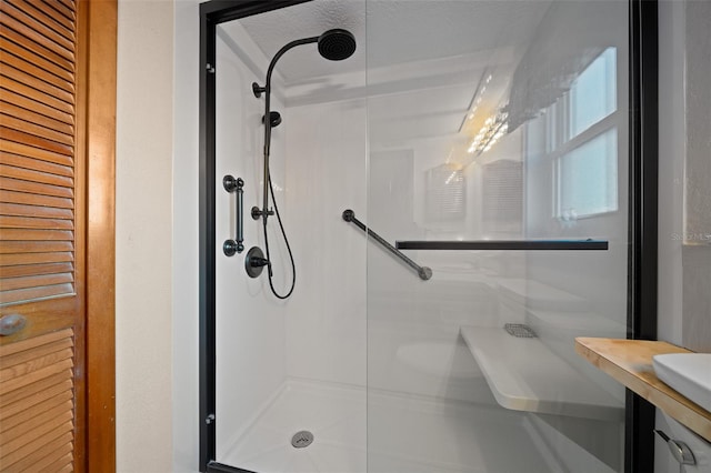 bathroom with a textured ceiling and walk in shower