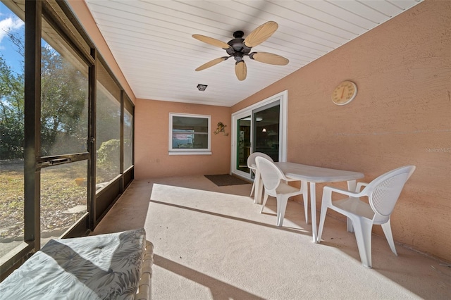 sunroom / solarium featuring ceiling fan