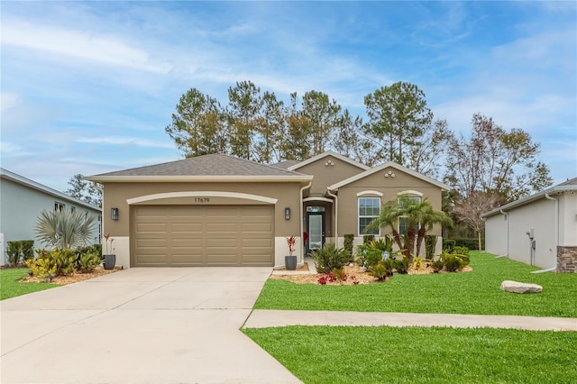 ranch-style home featuring a garage and a front yard