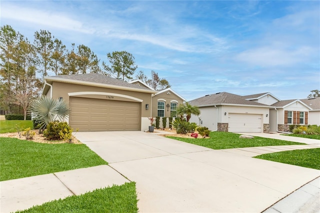 single story home with a garage and a front lawn