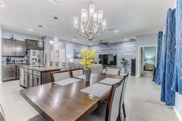 tiled dining area with sink and ceiling fan