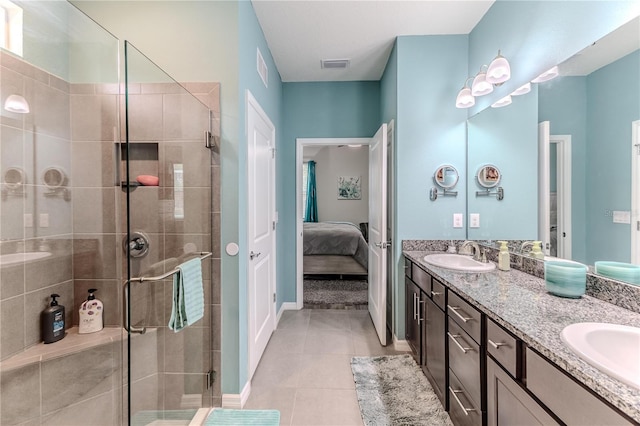 bathroom with tile patterned floors, an enclosed shower, and vanity