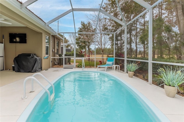 view of swimming pool featuring a patio, a lanai, and area for grilling