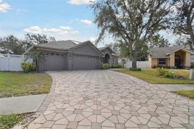 ranch-style house with a garage and a front lawn