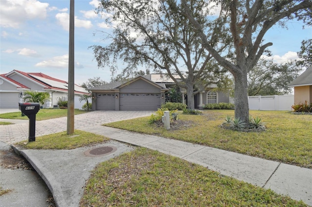 single story home featuring a garage and a front lawn