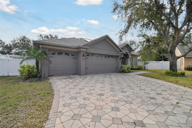 view of front of property featuring a garage and a front lawn