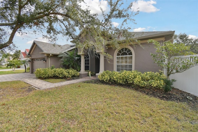 view of front of home with a garage and a front yard