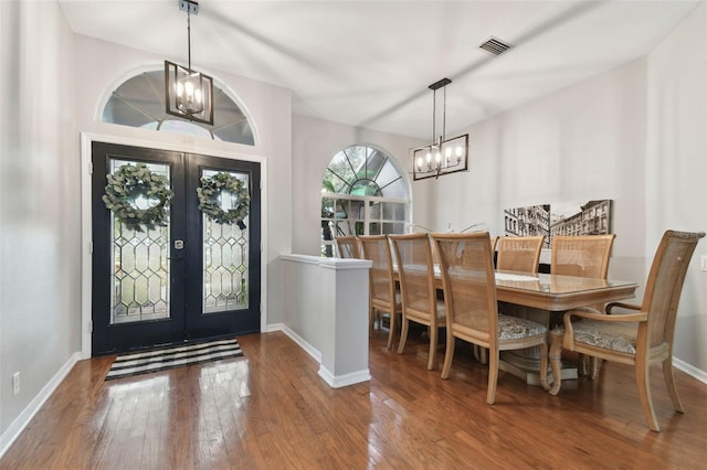 entrance foyer featuring a notable chandelier, hardwood / wood-style flooring, and french doors