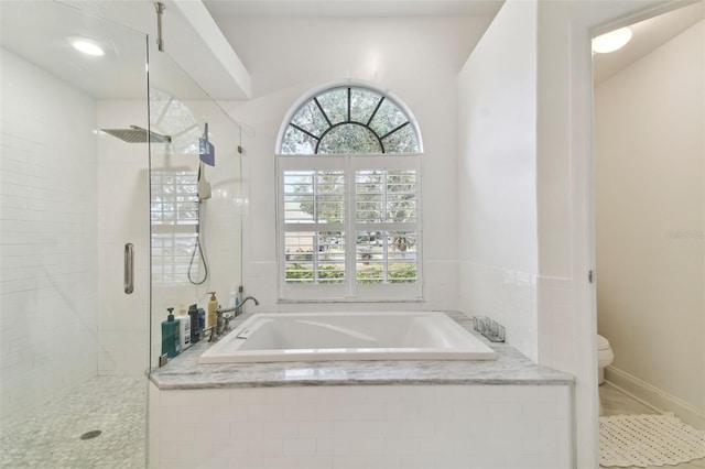 bathroom with tile patterned floors, toilet, and independent shower and bath