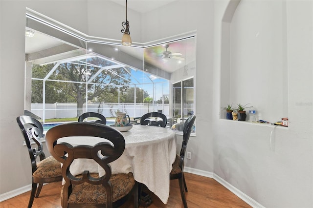 dining room with wood-type flooring and a wealth of natural light