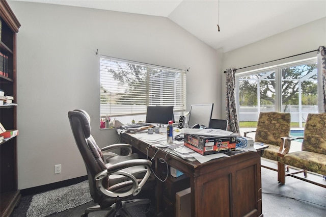 home office with lofted ceiling