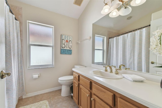 bathroom with vanity, toilet, tile patterned floors, and lofted ceiling