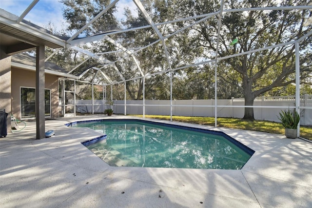 view of pool with a patio and a lanai