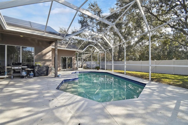 view of pool featuring area for grilling, a lanai, and a patio